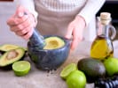 In-Office Team Building - Guacamole-Making Challenge: person making guacamole in a team building cooking class