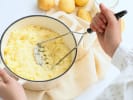 Cooking Class - Elevated English Dining - Date Night in Manhattan: person mashing potatoes in a pot