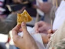 Food Tour - Experience Chinatown Like a Local in San Francisco: person on food tour eating onion pancakes