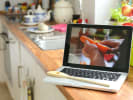 Online Cooking Class - Boozy Irish Comfort Food in Downtown Memphis: person peeling a carrot during an online cooking class