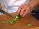 Online Cooking Class - Vegetarian Chili and Cornbread: person slicing a jalapeno
