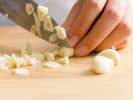 Cooking Class - Plant-Based Comfort Cuisine in Brooklyn: person slicing garlic