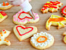 Cooking Class - Decorating Cookies With Royal Icing: person using royal icing to decorate cookies