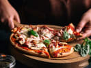 Cooking Class - Craft Homemade Pizza From Scratch in Dallas: picking fresh pizza slice