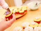 Cooking Class - Kids' Cupcake Party in Manhattan: piping frosting onto a cupcake