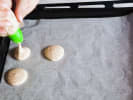 Cooking Class - Fun Macaron Workshop in Manhattan: piping macaron shells onto baking sheet