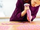 Cooking Class - Silver Platter Macarons in South Bay & Peninsula: chef carefully piping blueberry macaron shells onto baking sheet