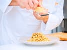 Team Building Cooking Class - Pasta Workshop for Teams in Downtown Chicago: plating fettuccine pasta Bolognese