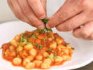 Cooking Class - Handmade Gnocchi & Marinara Workshop in Portland, OR: plating gnocchi pasta with marinara sauce and basil garnish