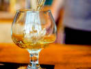 Online Mixology Class - Whiskey From Around the World: pouring whiskey into a sifter with ice