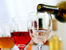 Virtual Wine Tasting - A Tour Through Mediterranean Wines: pouring white wine into a glass next to red wine
