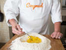 Cooking Class - Make Fresh Alfredo Pasta at a Wine Bar in Minneapolis: preparing fresh pasta dough with Cozymeal apron on