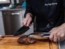 Private Chef - Romantic Gourmet Fare - Date Night: Chef slicing cooked steak on a wooden cutting board
