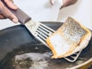 Team Building Cooking Class - Mystery Box Cooking Competition in Nashville: searing salmon in the pan