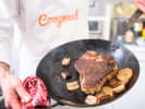 Cooking Class - Perfect Steakhouse in Denver: searing steak on an iron skillet pan