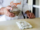 Cooking Class - Make Perfect Sushi Rolls in Minneapolis: seasoning sushi with sesame seeds