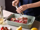 Cooking Class - Trattoria-Style Cooking - Date Night in Northern Virginia: close-up of chef seasoning raw steak in kitchen