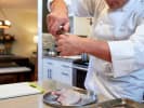 Cooking Class - Classic Taste of Spring in Downtown Dallas: seasoning chicken quarters with salt