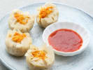 Cooking Class - Classic Dim Sum Feast in Downtown Dallas: shumai dumplings on a pastel plate with a dipping sauce on the side - Copy