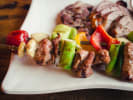 Cooking Class - Favorite Spring Dishes in Manhattan: skewered meat and vegetables on a white plate