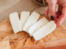 Online Cooking Class - Perfect Spanish Paella: sliced manchego cheese on a wooden cutting board