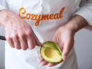 Team Building Cooking Class - Ultimate Dip Challenge With Guacamole & Salsa: slicing fresh avocado in Cozymeal apron