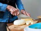 Team Building Cooking Class - Charcuterie Board Team Challenge in San Francisco: slicing hard cheese for charcuterie board