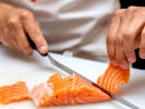 Cooking Class - Italian Home-Cooked Delights: slicing salmon on a white cutting board