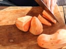 Cooking Class - Hearty Soups and Stews: slicing sweet potatoes on a wooden cutting board