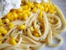Cooking Class - Seasonal Kitchen Creations in Northern Suburbs: Spaghetti with corn and whipped ricotta – A plate of spaghetti topped with sweet corn kernels, cracked pepper, and a dollop of whipped ricotta.