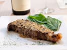 Cooking Class - Flavorful French Spring Feast in Northern Virginia: steak au poivre with mustard dressing on a white plate