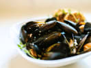 Online Cooking Class - Perfect Spanish Paella: steamed mussels on a white plate