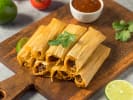 Cooking Class - The Art of Tamales: tamales on a wooden board with lime and salsa