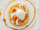 Cooking Class - Elegant French Spring Feast in Northern Virginia: tarte tatin on a light plate with ide cream on top and a drizzle of caramel
