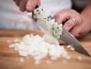 Cooking Class - French Countryside Brunch: thinly dicing onions on a wooden cutting board