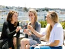 Virtual Wine Tasting - Premium Canned Red Wine and Chocolate: three women toasting with a glass of wine