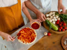 Cooking Class - Slice by Slice Pizza Creations: topping pizza with tomato sauce and choosing from selection of fresh toppings