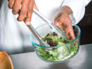 Team Building Cooking Class - Sardinian Secrets for Building Team Spirit in South Bay Los Angeles: tossing arugula salad in a bowl
