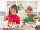 Cooking Class - Kids' Cupcake Party in Manhattan: two kids mixing ingredients in separate bowls