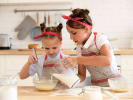 Cooking Class - Junior Bakers - Kids' 5-Day Culinary Camp in Manhattan: two young girls helping each other mix baking batter
