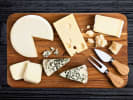 Virtual Wine Tasting - Comfort and Joy Holiday Wine: variety of cheeses on a wooden board