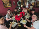 Cooking Class - Vibrant Vegan Delights in Las Vegas: with chef sitting around a square dining table and enjoying a freshly made pasta dish (1)