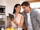 Online Cooking Class - Holiday Chutney From Scratch: woman holding an ipad for an online cooking class with her partner