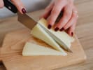 Virtual Wine Tasting - Classic Wine and Cheese Pairings: woman slicing cheese