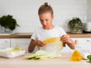 Cooking Class - Global Eats: Teen Summer Series in Northern Suburbs: teen girl is peeling fresh corn in a kitchen