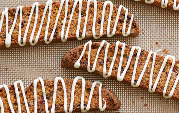 these crisp cranberry pistachio biscotti with white chocolate drizzle pairs perfectly with a cup of hot coffee or tea 