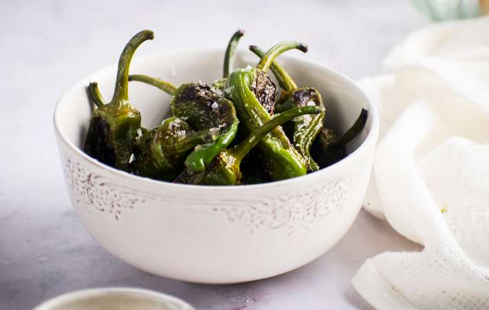 blistered shishito peppers are a gluten free party snack with a kick