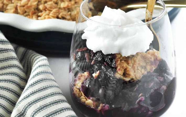 blueberry limoncello crisp with whipped coconut milk is a delicious and cozy vegan gluten free dessert 