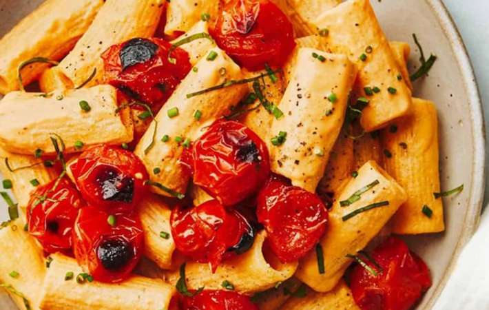 creamy red pepper pasta with blistered tomatoes is a simple but flavorful easy vegan pasta recipe