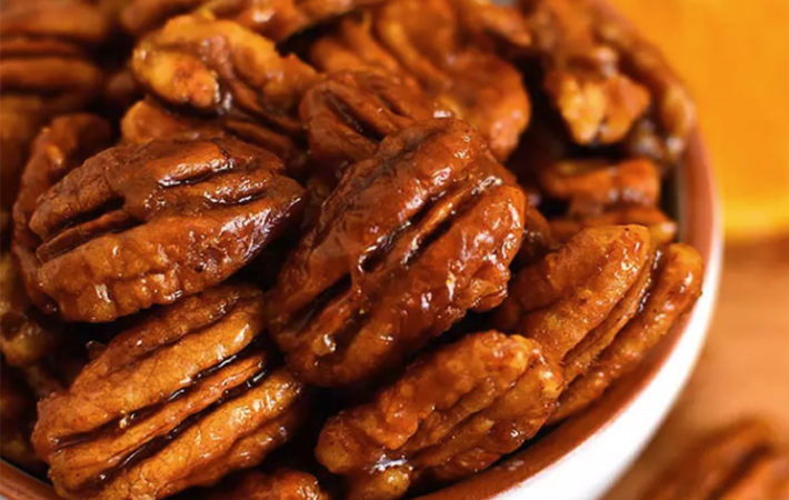 orange candied pecans are spiced and bright